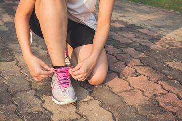 Woman tying shoelaces